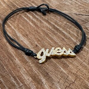 Guess Gold Crystal Script Bracelet with Black Cord